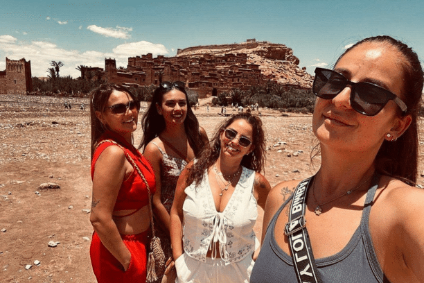 Travelers visiting the UNESCO-listed Ait Ben Haddou Kasbah in Morocco during a private cultural tour.