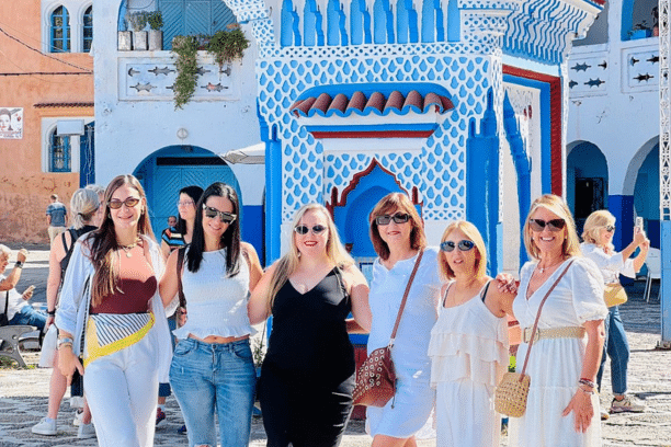 Travelers exploring the blue streets of Chefchaouen, Morocco, during a private Morocco tour.