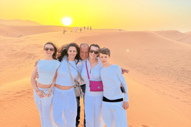 Family enjoying the Sahara Desert in Merzouga Morocco at sunset