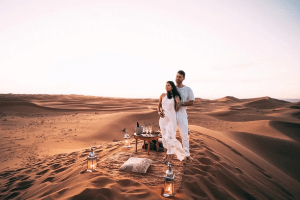 Couple enjoying a romantic desert experience in the Sahara near Merzouga Morocco